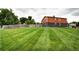 A spacious backyard features lush green grass and privacy fencing at 7300 Beech St, Arvada, CO 80005