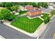 Aerial view of house with spacious backyard and long green lawn and curb at 7300 Beech St, Arvada, CO 80005