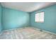 Simple light blue bedroom with neutral carpet, one window, and plain blinds at 7300 Beech St, Arvada, CO 80005