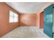A carpeted bedroom features natural light from the window and a closet for convenient storage at 7300 Beech St, Arvada, CO 80005