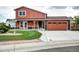 Inviting two-story home features a landscaped front yard, a ramp, and a two-car attached garage at 7300 Beech St, Arvada, CO 80005