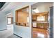 View of the kitchen featuring wooden cabinets and hardwood floors from the living room at 7300 Beech St, Arvada, CO 80005