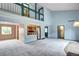 Open floor plan featuring a light blue living room, a loft, and views of the kitchen at 7300 Beech St, Arvada, CO 80005