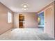 Well-lit living room featuring carpet flooring and a view to the kitchen with wooden cabinets at 7300 Beech St, Arvada, CO 80005