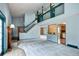 Spacious open floor plan with high ceilings, a loft, and a brick fireplace, painted in light blue at 7300 Beech St, Arvada, CO 80005
