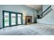 Open floor plan featuring a light blue living room with a fireplace and a door to the backyard at 7300 Beech St, Arvada, CO 80005
