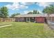 Spacious backyard with a well-maintained lawn, wood fence, and charming brick home exterior at 4715 Garland St, Wheat Ridge, CO 80033