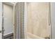 Bathroom featuring tub with gray and white-striped shower curtain and modern tile at 4715 Garland St, Wheat Ridge, CO 80033