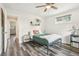 Comfortable bedroom with wood-look flooring, ceiling fan, and access to an en-suite bathroom at 4715 Garland St, Wheat Ridge, CO 80033