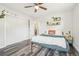 Cozy bedroom with dark wood floors, ceiling fan, and minimalist decor at 4715 Garland St, Wheat Ridge, CO 80033