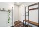 Inviting entryway with wood-look flooring, coat rack, mirror, and floating shelves at 4715 Garland St, Wheat Ridge, CO 80033
