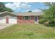 Charming single-story brick home with a well-maintained lawn and attached two-car garage at 4715 Garland St, Wheat Ridge, CO 80033