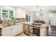 Stylish kitchen with stainless steel appliances, granite countertops, and a cozy dining area at 4715 Garland St, Wheat Ridge, CO 80033