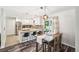 Bright kitchen with granite countertops, stainless steel appliances, and dining table with seating at 4715 Garland St, Wheat Ridge, CO 80033
