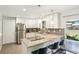 Modern kitchen with white cabinets, granite countertops, stainless steel appliances, and breakfast bar seating at 4715 Garland St, Wheat Ridge, CO 80033
