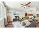 Inviting living room with dark floors, a comfortable seating area, and an opening to the updated kitchen at 4715 Garland St, Wheat Ridge, CO 80033