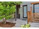 Home entrance with a modern door, wood accents, and updated lighting at 2507 Moline St, Aurora, CO 80010