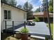 Backyard deck featuring a dining table with chairs, a small fence, and string lights at 3209 E Yale Way, Denver, CO 80210