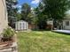 Backyard features include an outdoor shed, garden beds, and a well-manicured lawn at 3209 E Yale Way, Denver, CO 80210