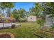 Large backyard featuring storage sheds, a wooden deck, and a well manicured lawn at 3209 E Yale Way, Denver, CO 80210