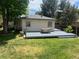 Large backyard with deck, outdoor dining area, and grass at 3209 E Yale Way, Denver, CO 80210