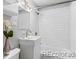 Cozy bathroom featuring a white vanity, subway tile surround, and shower-tub combo at 3209 E Yale Way, Denver, CO 80210