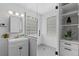 Modern bathroom with tiled shower, glass block windows, and updated vanity at 3209 E Yale Way, Denver, CO 80210