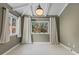 Bedroom with neutral walls, beamed ceiling, carpeted floors, and large windows for natural light at 3209 E Yale Way, Denver, CO 80210