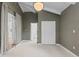 Bedroom with vaulted ceilings, carpeted floors, and ample closet space at 3209 E Yale Way, Denver, CO 80210