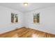 Bedroom with hardwood floors and two large windows offering natural light at 3209 E Yale Way, Denver, CO 80210