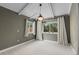 Bedroom with neutral walls, beamed ceiling, carpeted floors, and large windows for natural light at 3209 E Yale Way, Denver, CO 80210