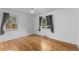 Light-filled bedroom with hardwood floors, large windows, and ceiling fan at 3209 E Yale Way, Denver, CO 80210