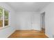 Bright bedroom features hardwood floors, white walls, and a window at 3209 E Yale Way, Denver, CO 80210