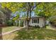 Charming home featuring a well-maintained lawn, mature trees, and a welcoming walkway leading to the front entrance at 3209 E Yale Way, Denver, CO 80210