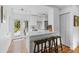 Modern kitchen featuring white cabinets, sleek countertops, stainless steel appliances, and an inviting breakfast bar at 3209 E Yale Way, Denver, CO 80210