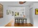 Modern kitchen featuring white cabinets, sleek countertops, stainless steel appliances, and an inviting breakfast bar at 3209 E Yale Way, Denver, CO 80210