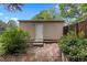 Backyard shed with a door, brick pathway and surrounding landscaping at 3209 E Yale Way, Denver, CO 80210