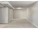 Spacious carpeted basement with light gray walls and trim and overhead lighting at 11917 Lavinia Way, Northglenn, CO 80233