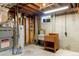 Utility room with a water heater, furnace, sink, and exposed ceiling at 11917 Lavinia Way, Northglenn, CO 80233
