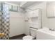 Bathroom featuring a shower, toilet, sink with vanity, and built in storage shelves at 11917 Lavinia Way, Northglenn, CO 80233