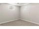 Cozy bedroom with neutral carpet, light gray walls, and natural light from two windows at 11917 Lavinia Way, Northglenn, CO 80233