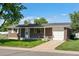 Brick home with attached one car garage, small front porch and well maintained lawn at 11917 Lavinia Way, Northglenn, CO 80233
