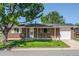 Charming brick home with a well-maintained lawn and an attached one car garage at 11917 Lavinia Way, Northglenn, CO 80233