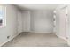 Spacious living area with carpet, neutral paint, closet, and access to other rooms at 11917 Lavinia Way, Northglenn, CO 80233