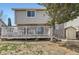 Backyard view featuring an outdoor deck, a shed, and partial greenery with stone landscaping at 4222 S Himalaya Way, Aurora, CO 80013