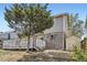 Home exterior with a large tree in the backyard, a wooden deck, and a storage shed at 4222 S Himalaya Way, Aurora, CO 80013