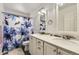 Spacious bathroom with double vanity, floral shower curtain and great lighting at 4222 S Himalaya Way, Aurora, CO 80013