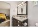 Bathroom with granite countertop, dark wood cabinets, and recessed lighting at 4222 S Himalaya Way, Aurora, CO 80013