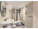 Updated bathroom featuring a glass shower with decorative tile, a modern sink, and a sleek design at 4222 S Himalaya Way, Aurora, CO 80013