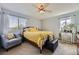 Bright bedroom with a ceiling fan, large windows, and stylish decor at 4222 S Himalaya Way, Aurora, CO 80013